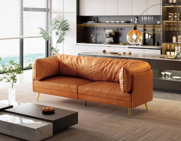 Contemporary living room with a Vesgantti orange leather couch and a coffee table, showcasing mid-century modern design.