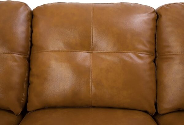 Close-up image of a Beverly Fine Furniture caramel tan leather sectional sofa, emphasizing its luxurious texture and style.